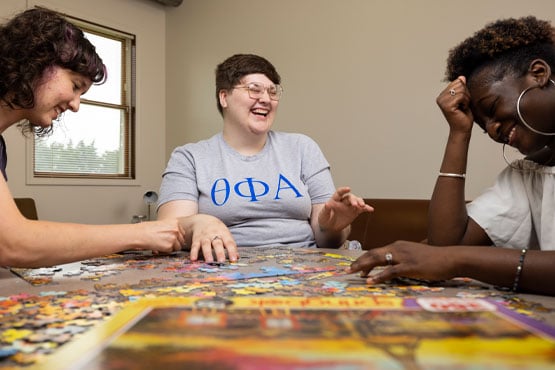 Housing residents putting a puzzle together at UM-Flint.